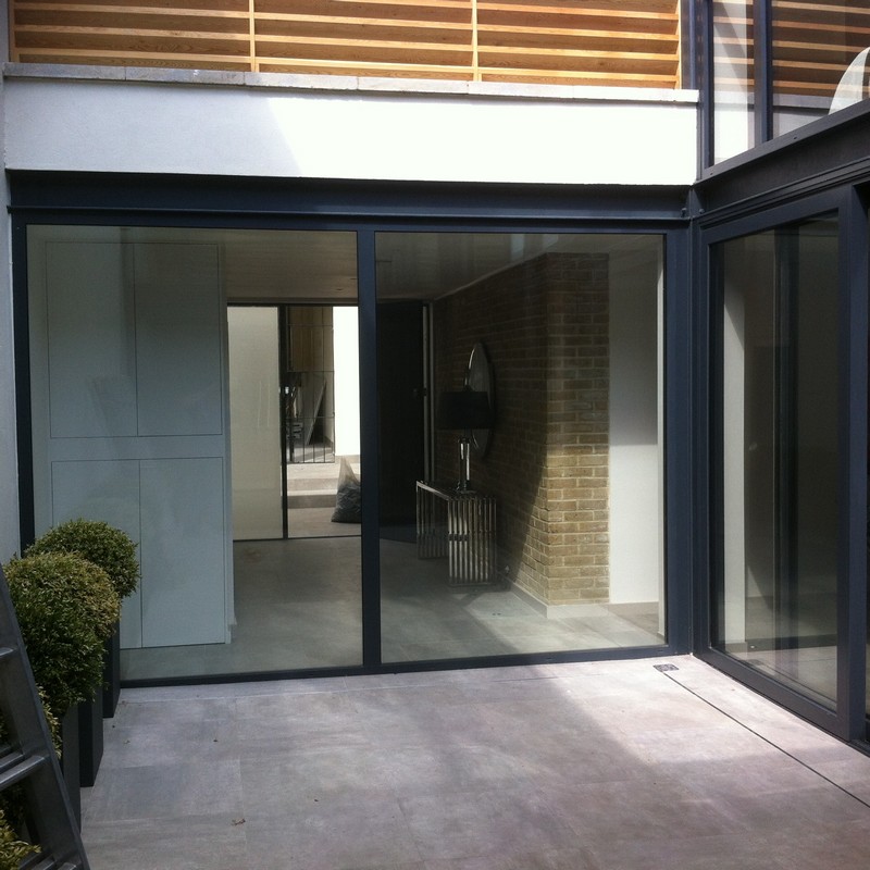 Floor-to-ceiling sliding doors opening to courtyard in Chessington