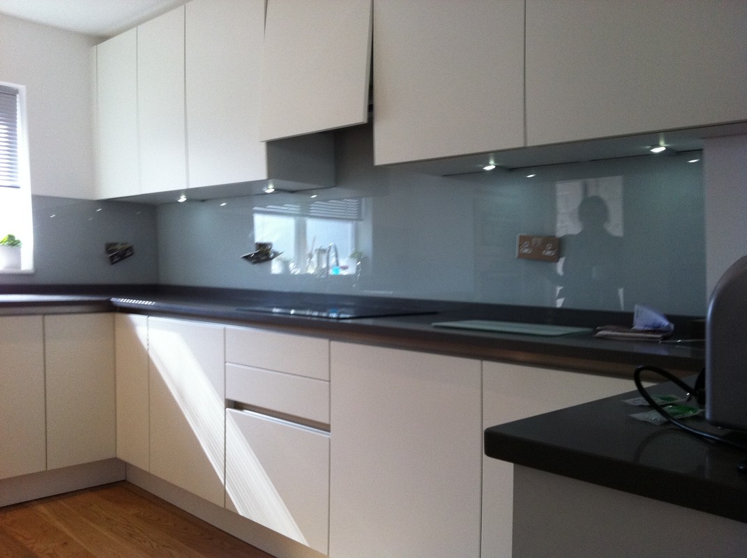 Grey glass kitchen splashback with LED lighting in Chessington