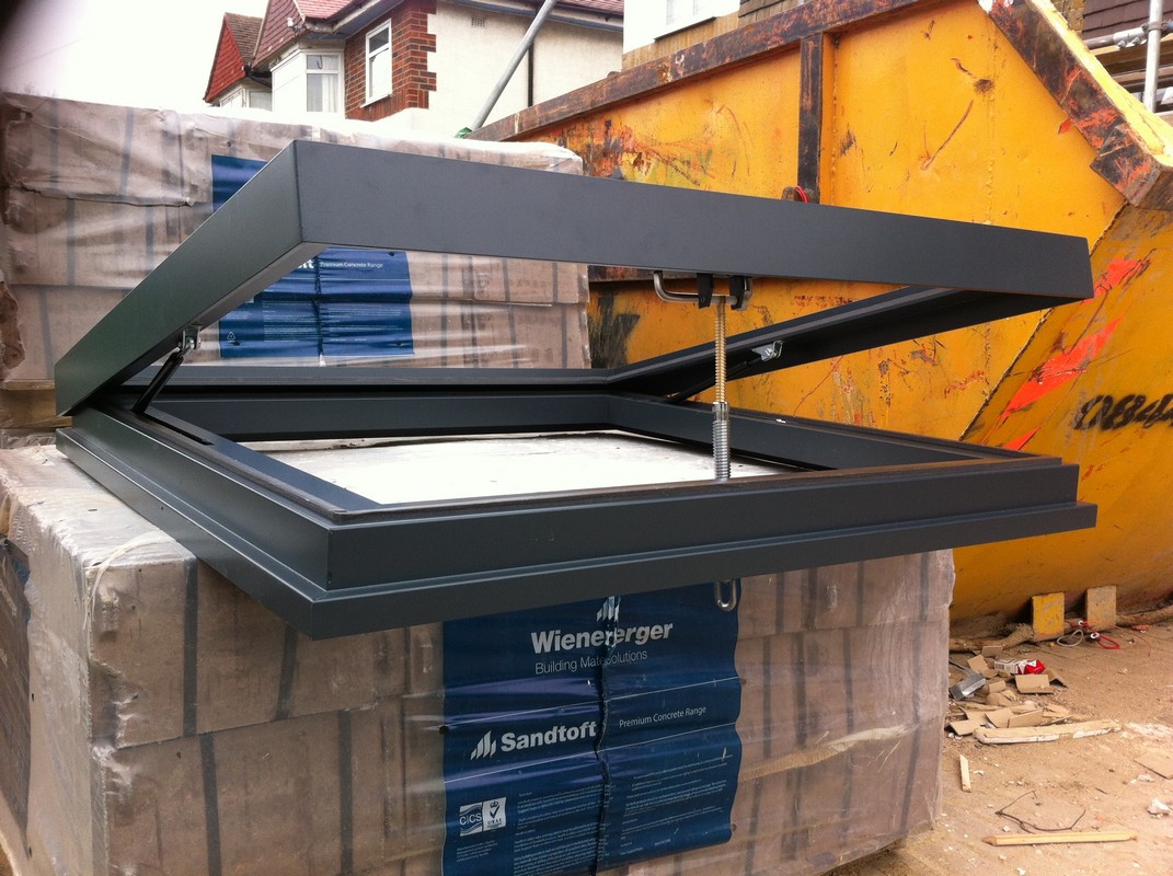 Opening flat roof skylight in anthracite grey installed in Chessington