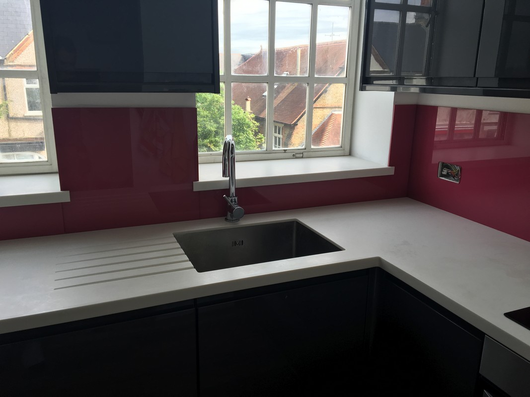 Deep plum coloured glass splashback in modern Chessington kitchen